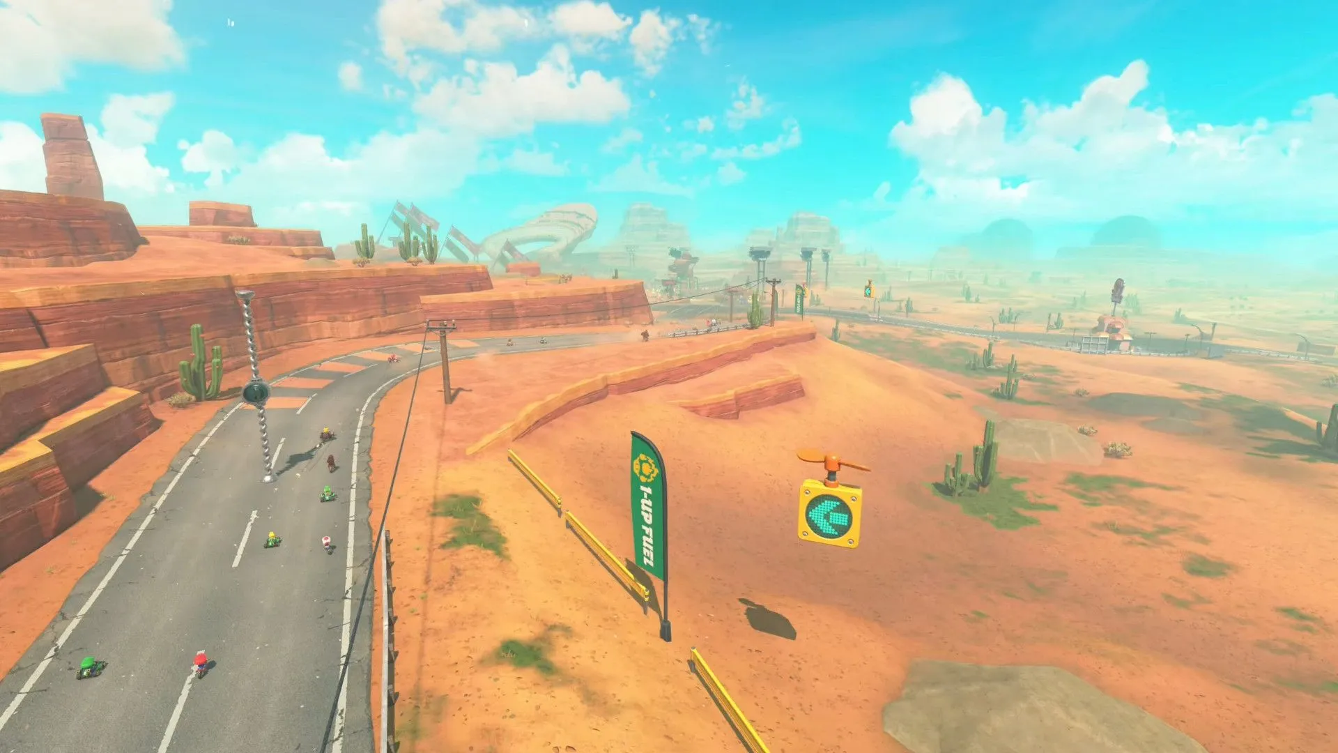 Góc nhìn từ trên cao một đường đua sa mạc trong Mario Kart World, minh họa đa dạng cảnh quan và đồ họa chi tiết.