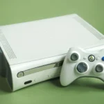 Máy chơi game Xbox 360 màu trắng cùng tay cầm điều khiển, biểu tượng cho kỷ nguyên thành tích game hiện đại.