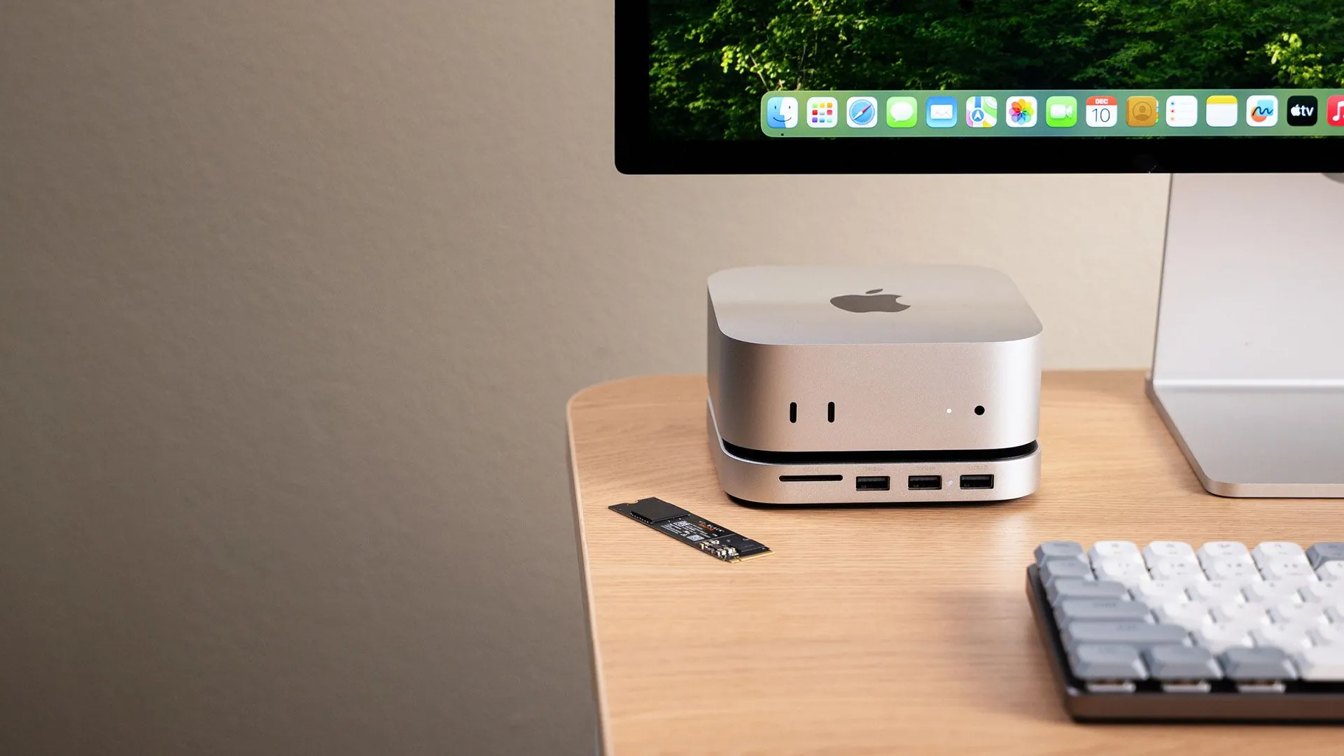 Satechi Mac Mini Hub shown in a lifestyle setting on a desk next to a monitor