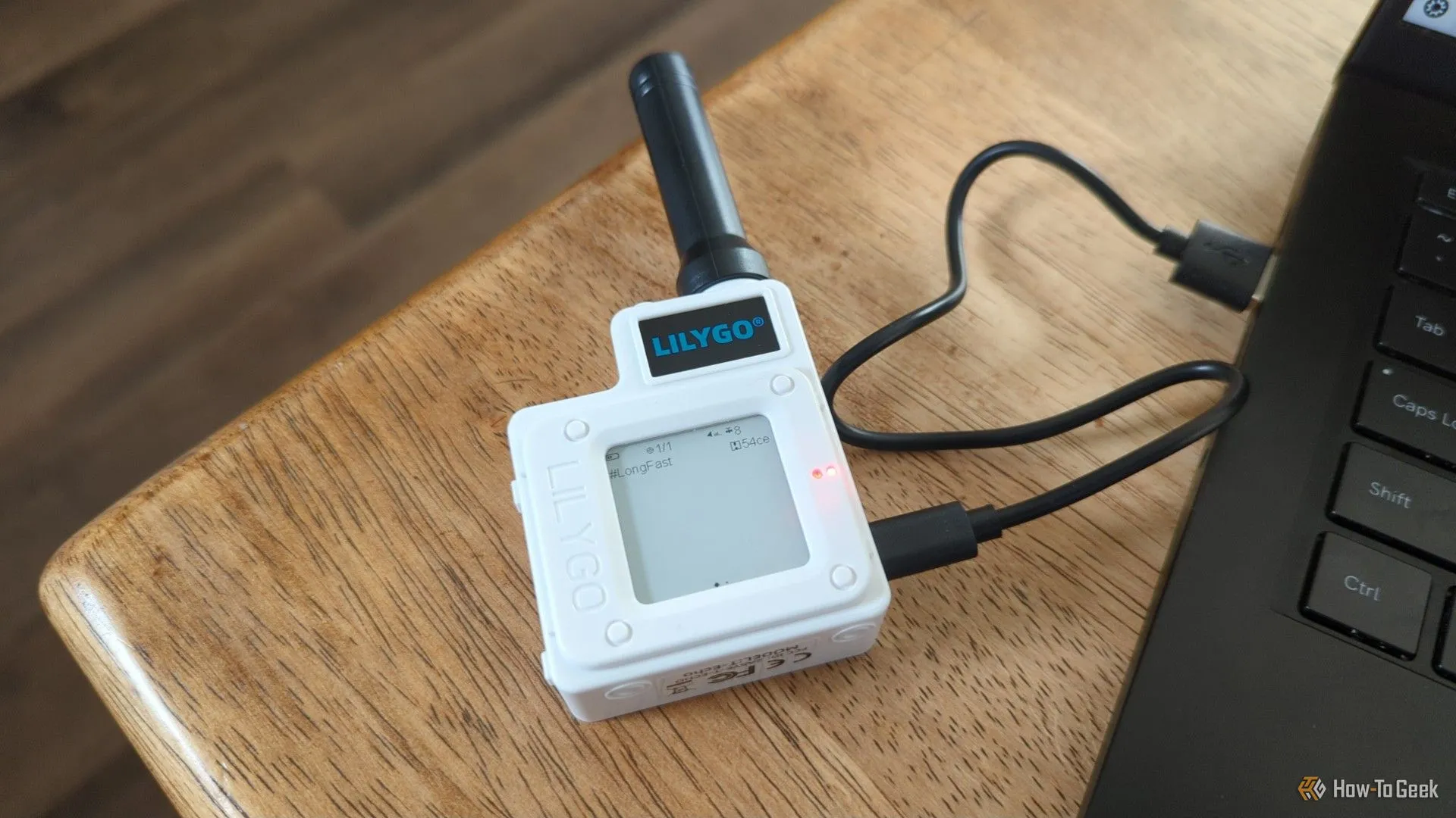 Thiết bị radio LoRa Lilygo T-Echo kết nối với laptop, minh họa khả năng giao tiếp không dây tầm xa.